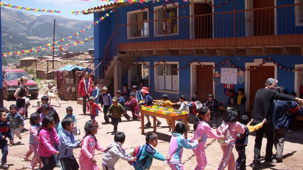 Bambini fanno girotondo con i volontari del progetto solidale in Perù